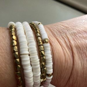 5 white and gold stretch bracelets